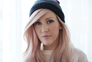 woman wearing black knit cap and white top