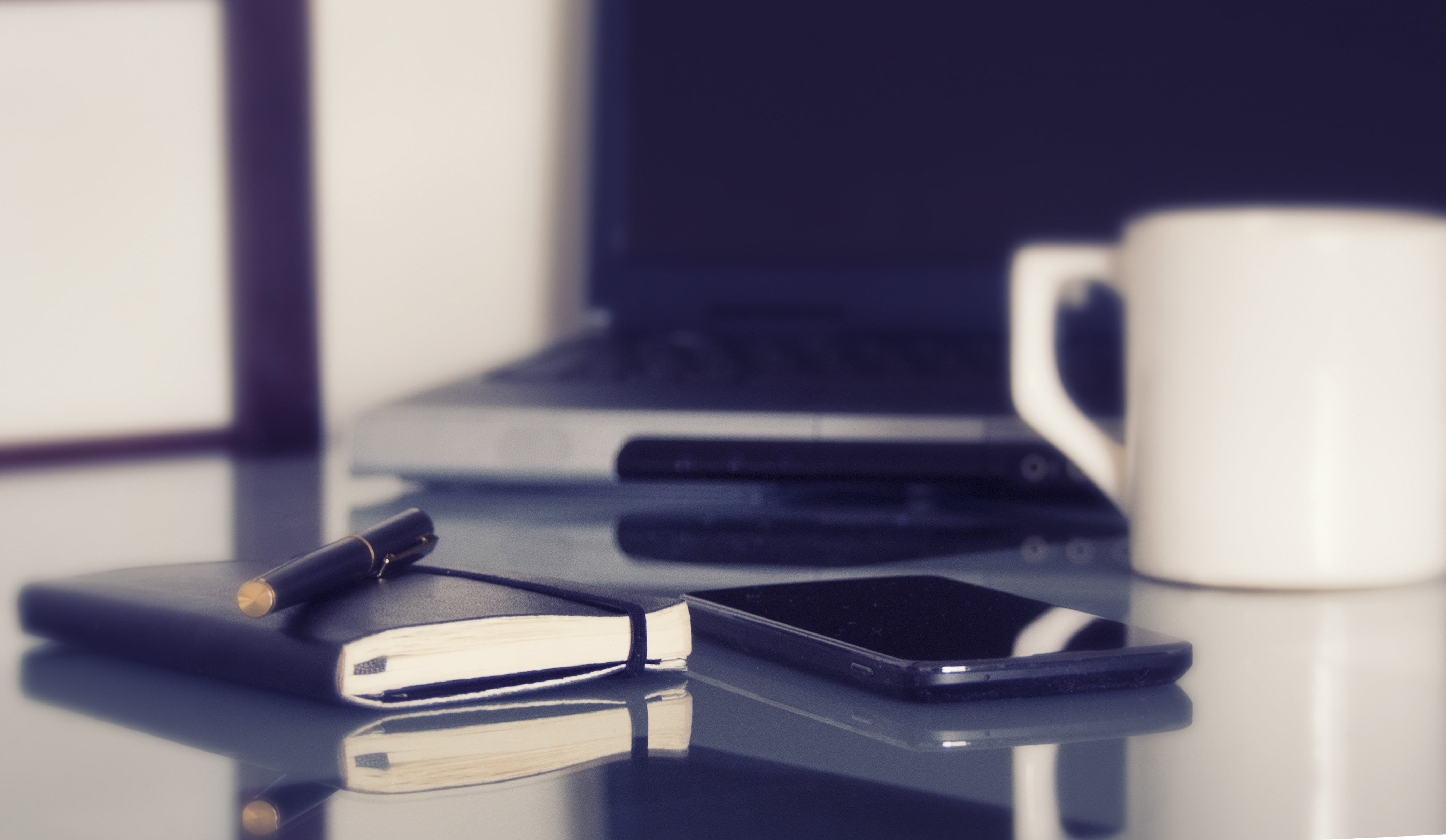 space gray iPhone 6 beside black covered book