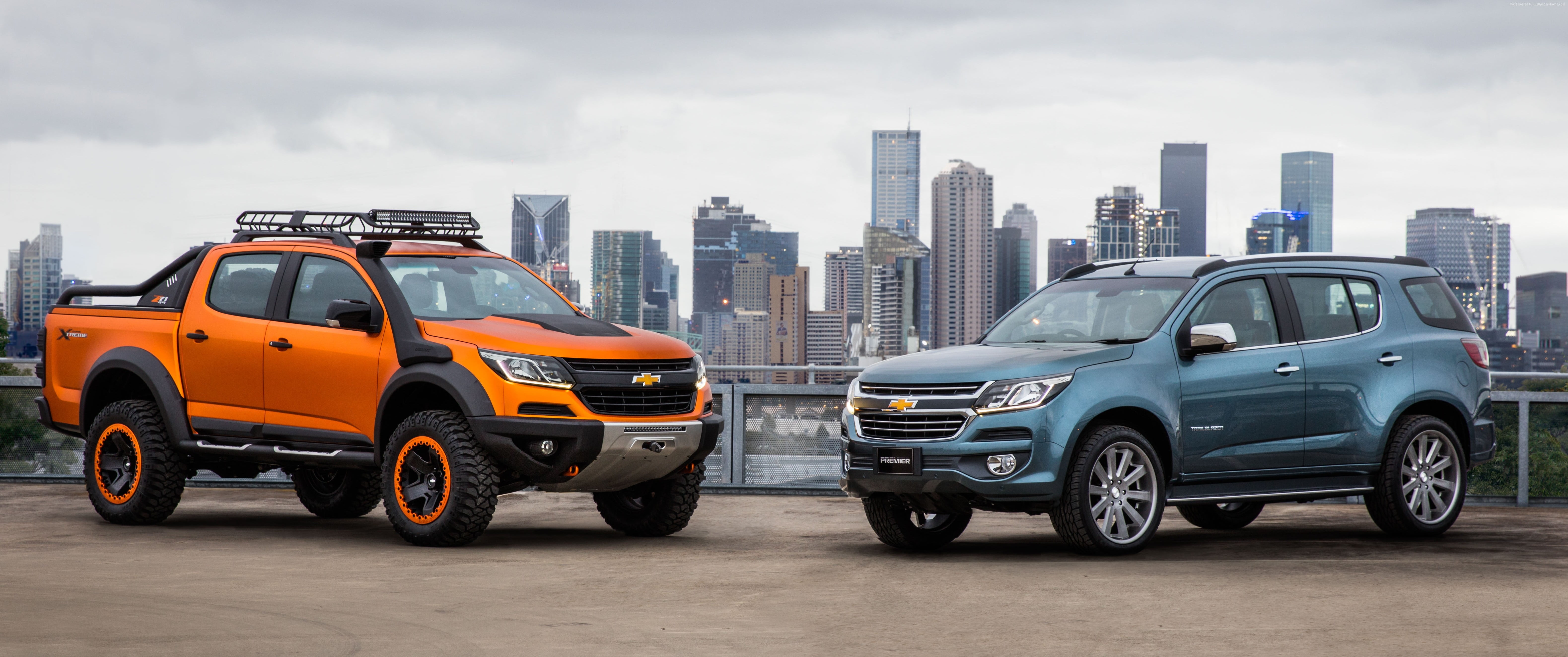 two orange and blue Chevrolet cars