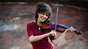 woman playing violin while standing