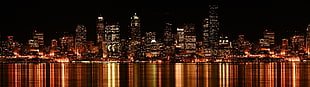 city buildings during night time HD wallpaper