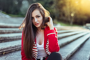 woman in red and white blazer with white scoop-neck shirt posing for a photo