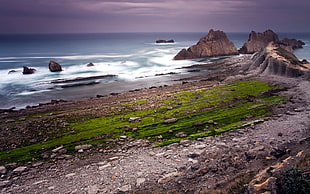 landscape photography of ocean and boulder rocks HD wallpaper
