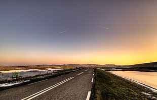 gray concrete road with white traffic lines beside body of water during sunset, camperduin HD wallpaper