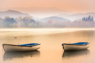 two white canoes near mountain at daytime, banyoles