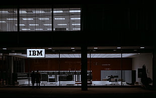 black flat screen TV with black wooden TV stand, IBM