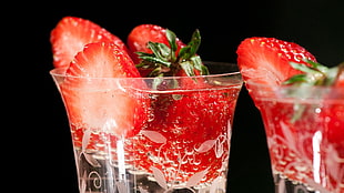 strawberry on top of clear glass of water