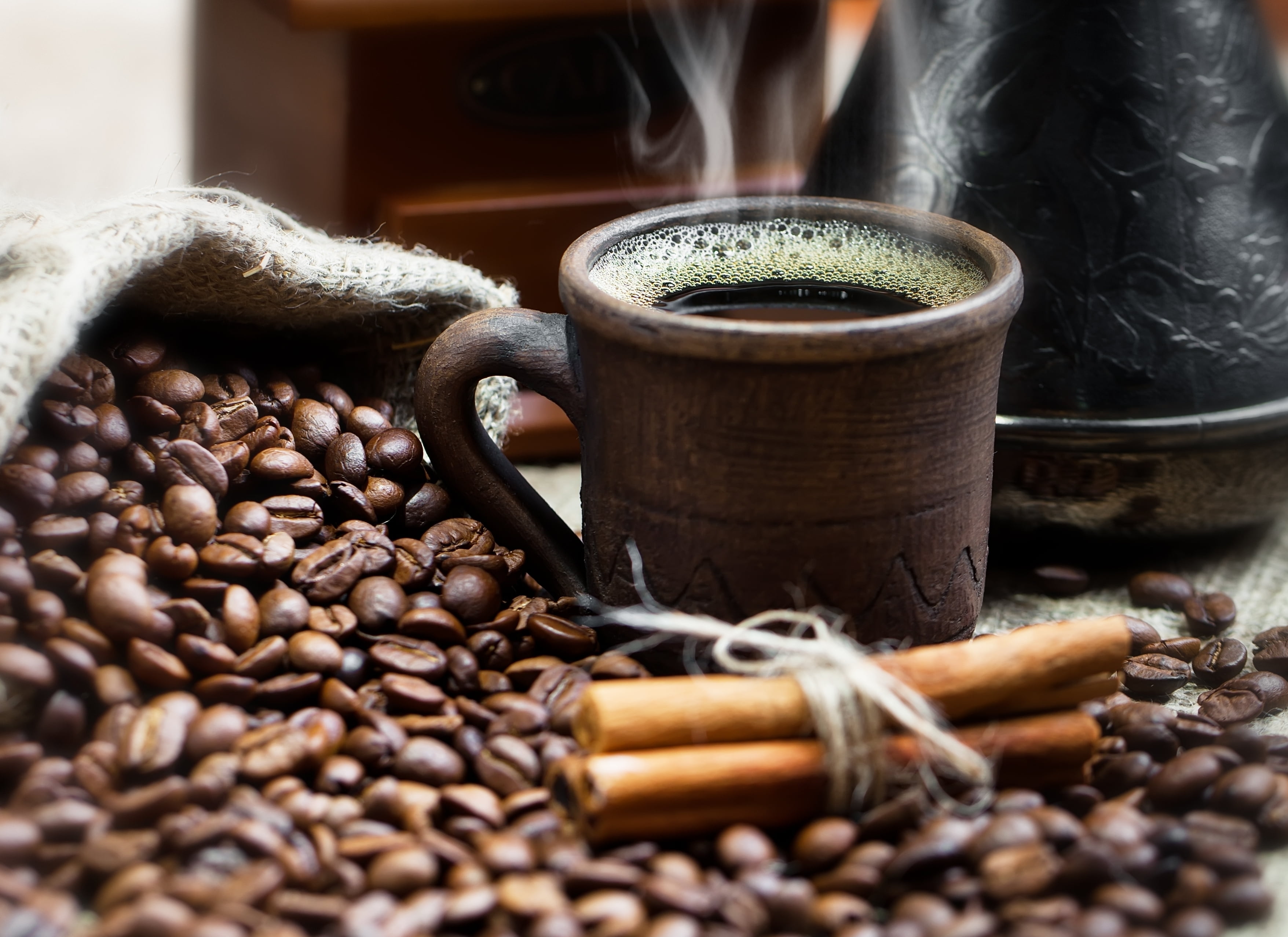 coffee in brown mug with coffee beans