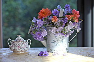 pink and purple flower in white steel pitcher