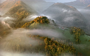aerial photo of foggy mountain during daytime HD wallpaper
