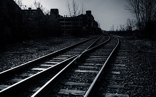 gray scale photo of train rails