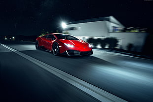 red Lamborghini Huracan running on road in timelapse photographyu