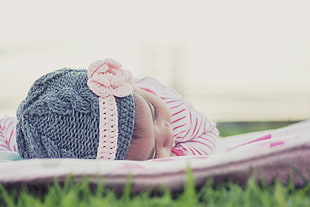baby wearing gray knitted beanie with pink headband