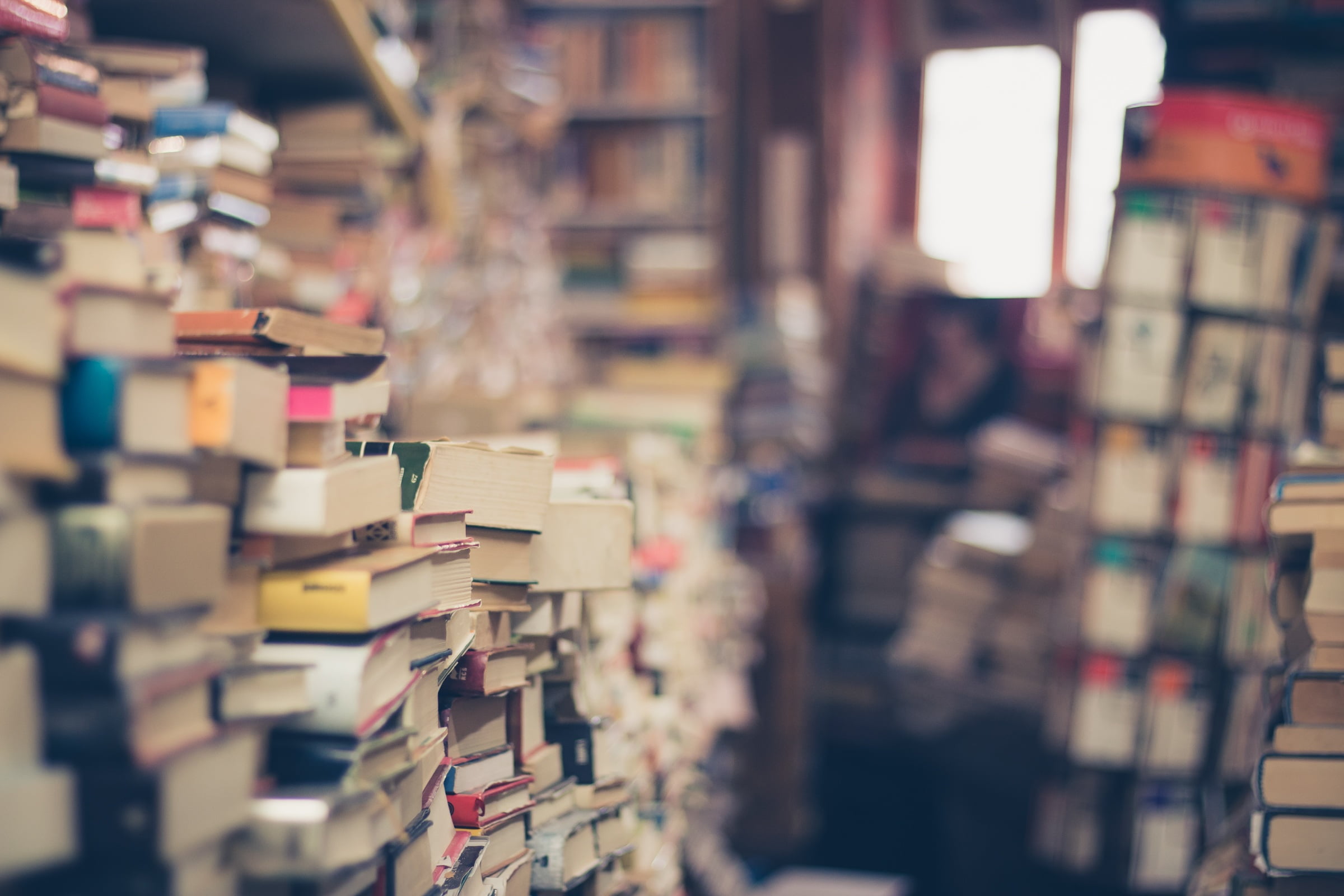 shallow focus photography of books in library