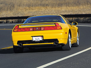 yellow Acura sports car