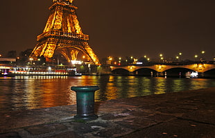 green dock post across Eiffel Tower during night HD wallpaper