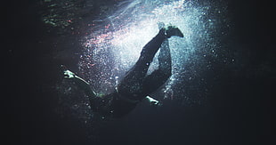 person diving during with rays of sun