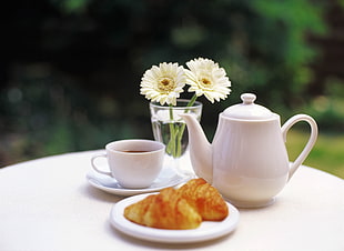 white ceramic teapot with teacup and saucer