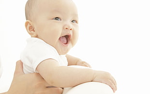 person holding baby smiling