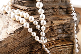 white pearl hanging on brown rock