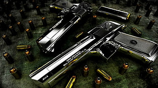 two silver semi-automatic pistols
