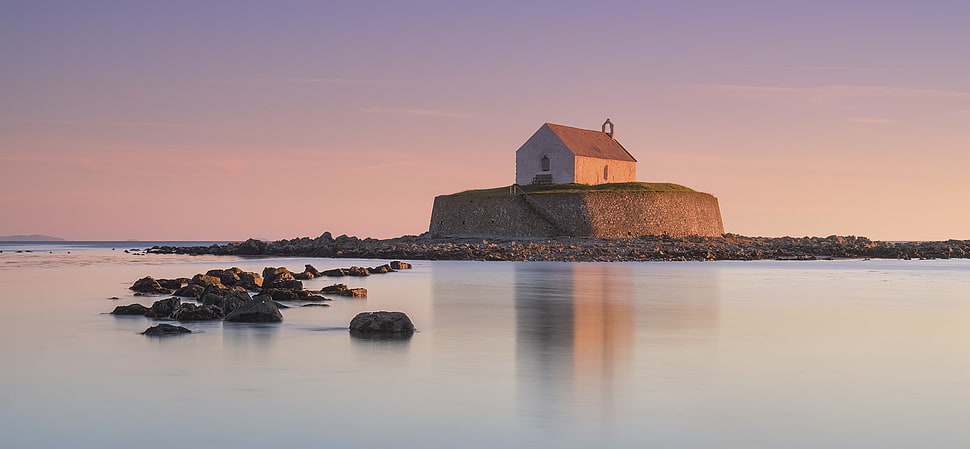 house on rock formation near body of water, porth, anglesey HD wallpaper