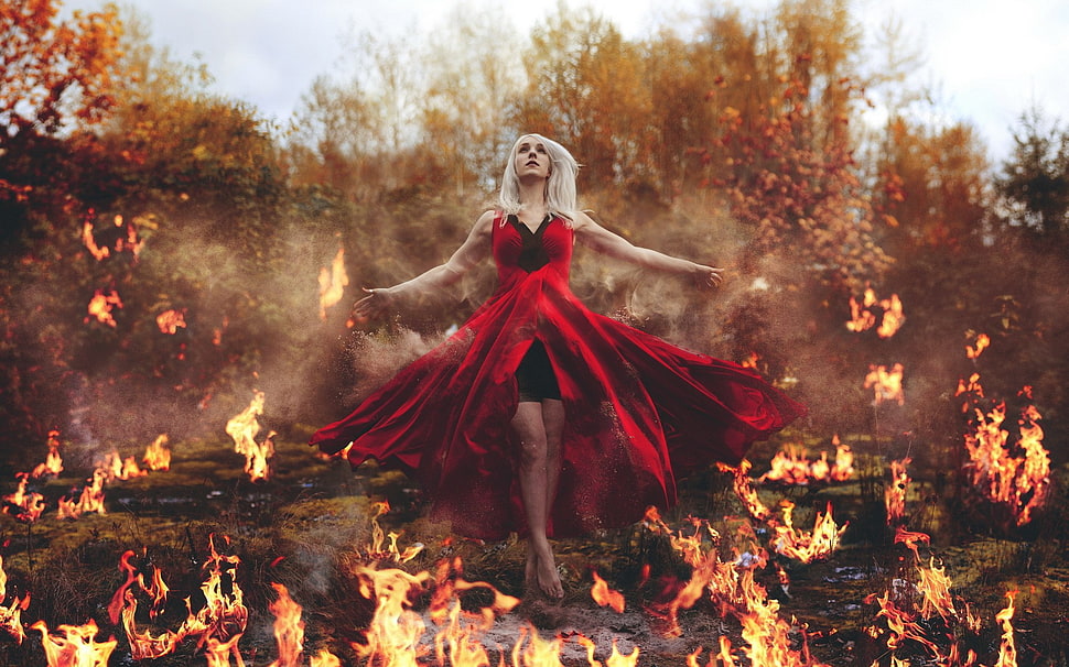 woman in red sleeveless dress standing on burning ground HD wallpaper