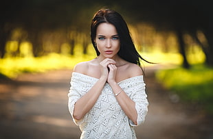 woman wears white off-shoulder dress