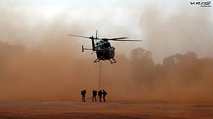 four soldier under black helicopter during daytime