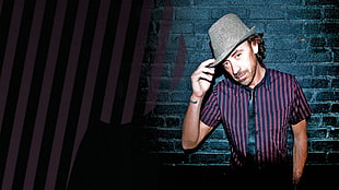 man wearing purple striped button-up shirt and gray hat
