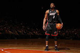 selective focus photography of Dwyane Wade holding ball