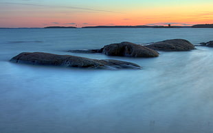 rocks on a beach at sunset