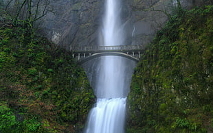 landscape photo of water falls, green trees, and mountains, waterfall, bridge