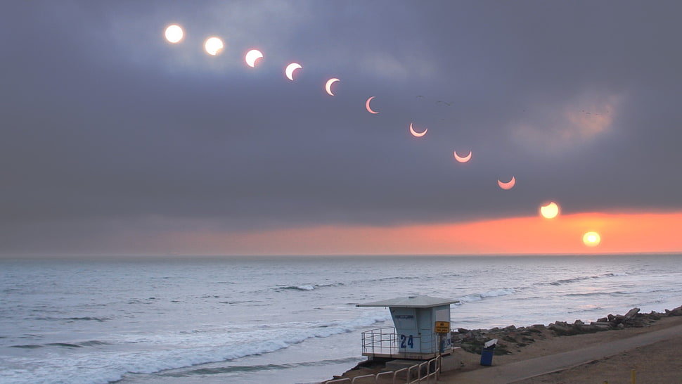 white lifeguard house, solar eclipse, sea, horizon, sky HD wallpaper