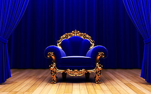 photo of blue padded chair with gold-colored base on brown wooden surface