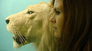 brown woman beside lion