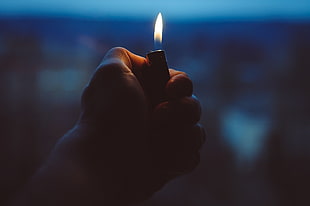 person holding disposable lighter