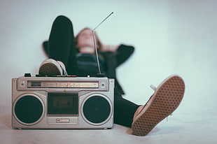 black and gray radio player, photography, lying down, music
