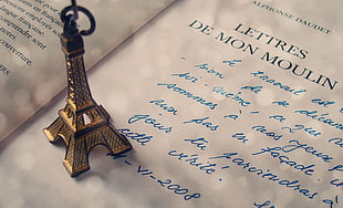 brown Eiffel Tower miniature on titled book