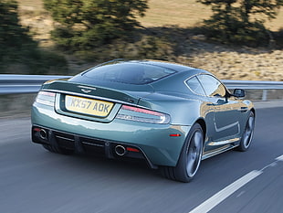 gray Aston Martin coupe on gray asphalt road