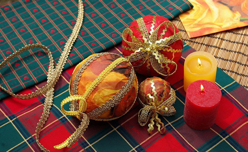 two red and orange pillar candles beside baubles HD wallpaper