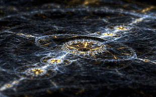 close-up photo of gold-colored and black surface with sun ray