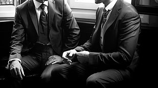grayscale photo of two person wearing blazersq, men, suits