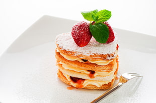 pastry with strawberry toppings on white plate