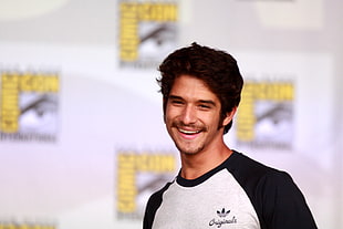 man wearing black and white Adidas shirt and smiling HD wallpaper