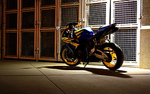 black , yellow and blue sports bike