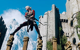 male character wearing black pants beside castle poster