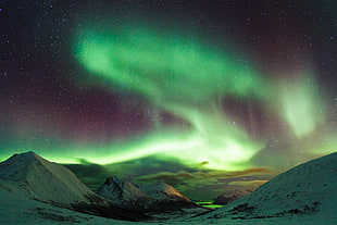 snow covered mountains with aurora background photo