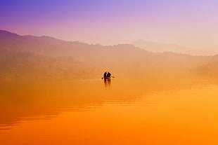 two people riding canoe boat during sunset view photo