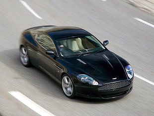 timelapse photography of black Aston Martin coupe